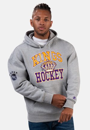 Gray hoodie with a front graphic reading "KINGS HOCKEY" in purple and yellow. Features a crown design and NHL logo on left sleeve.