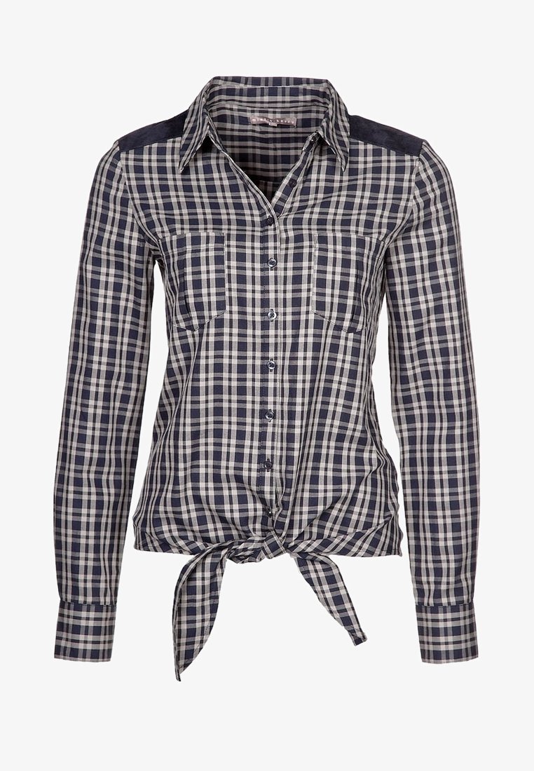 Sininen ja valkoinen ruudullinen paita pitkillä hihoilla, nappikiinnitys, kaksi rintataskua ja solmittu etuosa. Pehmeä, kudottu kankaan rakenne.