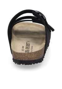 Sandale en daim noir avec plusieurs brides croisées, semelle intérieure en liège, semelle en caoutchouc, design plat et surface texturée. Comprend l'imprimé du logo de la marque.