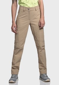 Beige Outdoor-Hosen aus leichtem Stoff, mit Fronttaschen, einer dezenten Seitentasche und einem Reißverschluss.