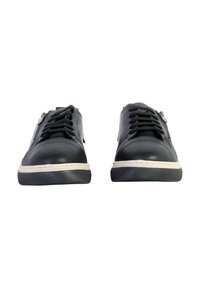 Black leather sneakers with a rounded toe, white rubber sole, prominent laces, and stitching details. Features a side zipper for easy wear.