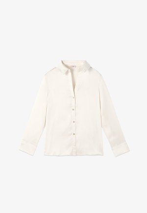 Kermansävyinen napillinen paita, valmistettu sileästä kankaasta; siinä on klassinen kaulus, pitkät hihat ja napit edessä.