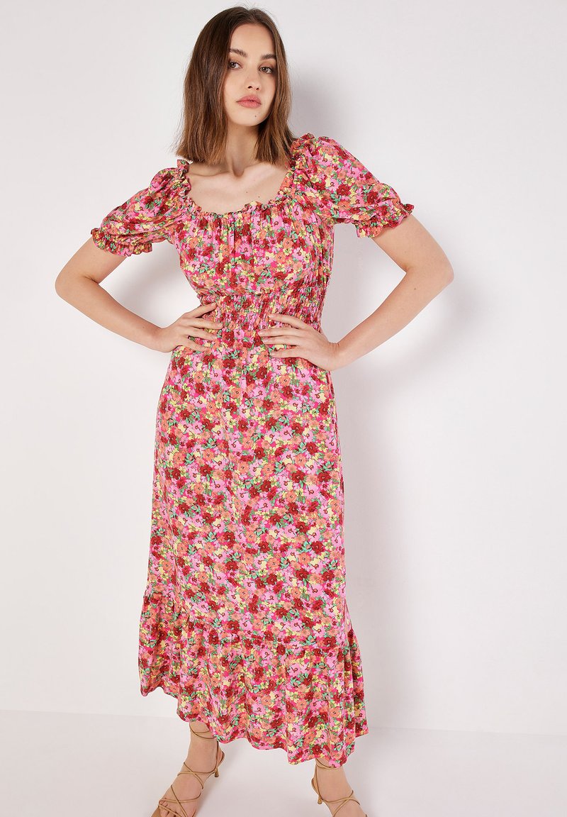 Blumiges Maxikleid mit Puffärmeln. Hat einen rosa Hintergrund und farbenfrohe Blumenmuster. Elastischer Taillenbund und Rüschensaum.