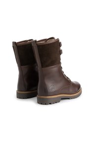 Bruine leren laarzen met een suède bovenzijde, veterbundel aan de voorkant, drie knopen op de schacht en een gestructureerde rubberen zool. Logo ingedrukt aan de zijkant.