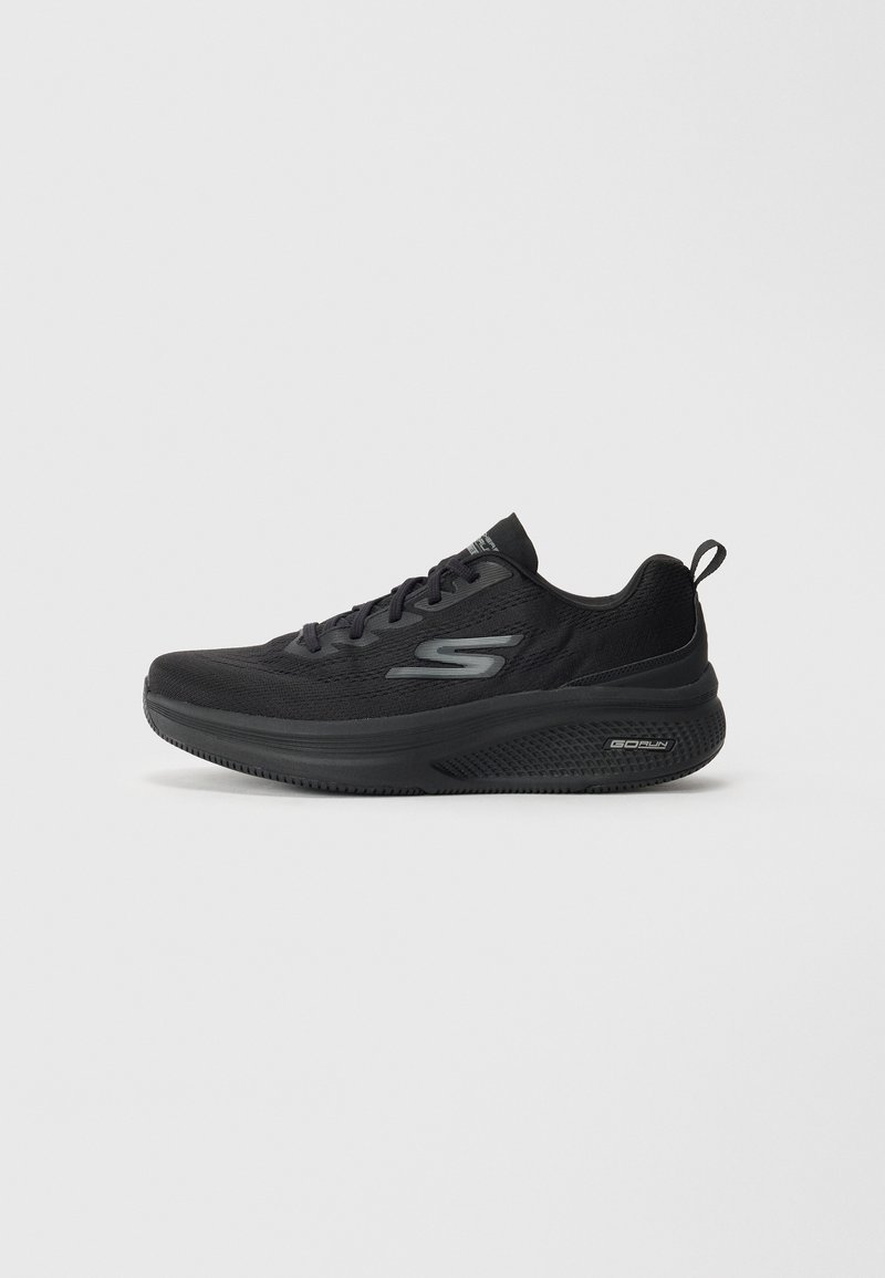 Black athletic shoe with a textured mesh upper, cushioned sole, and logo accent. Lightweight design features lace-up closure and pull tab.