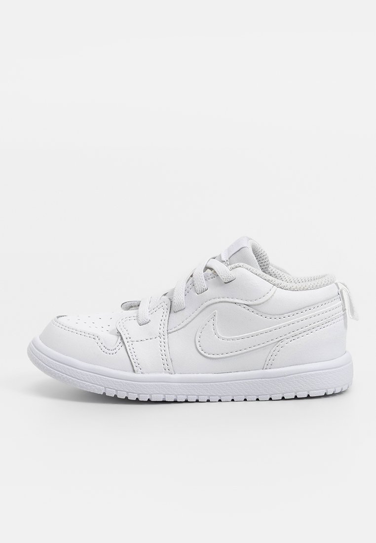 Zapatilla de piel blanca con puntera perforada, cierre de cordones y collar acolchado. Cuenta con una suela de goma duradera y un logo en el lado.