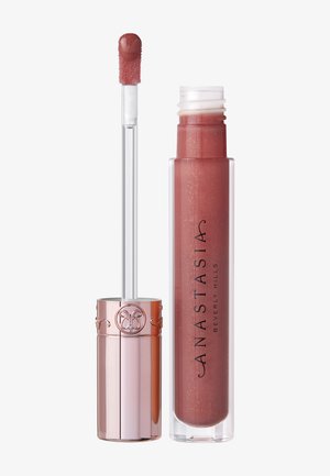 Glänzende flüssige Lippenfarbe in einem transparenten Röhrchen mit einem weichen Applikator, versehen mit einem roségoldenen Verschluss. Der Farbton ist ein gedämpftes Mauve mit dezentem Schimmer.