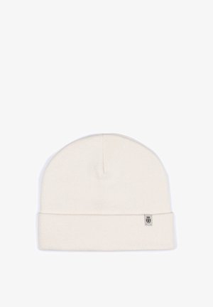 Cream-colored knit beanie with a folded cuff, made of soft material, featuring a small branded label on the side. Simple and seamless design.