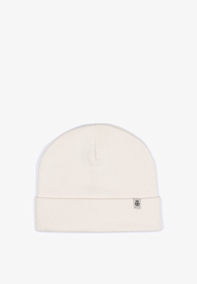 Cream-colored knit beanie with a folded cuff, made of soft material, featuring a small branded label on the side. Simple and seamless design.