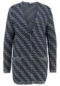 Cardigan en maille bleu marine et blanc à manches longues, devant ouvert et deux poches avant, présentant un motif losange texturé sur toute la surface.