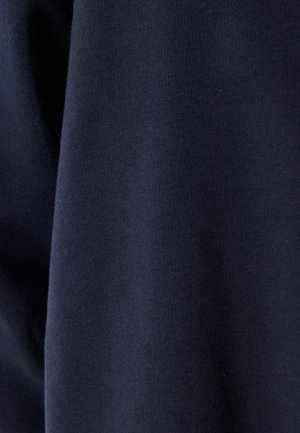 Marineblåt bomuldsstof, glat tekstur og ensartet overflade med let stræk. Ingen mønstre eller synlige sømme er til stede.