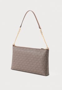Brown designer clutch bag with repeated "MK" pattern, gold chain strap, and top zipper closure on light background.