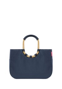 Sac fourre-tout en tissu bleu marine avec une forme structurée, doté d'une poignée circulaire accentuée d'or et de poignées texturées contrastantes sur la poignée.