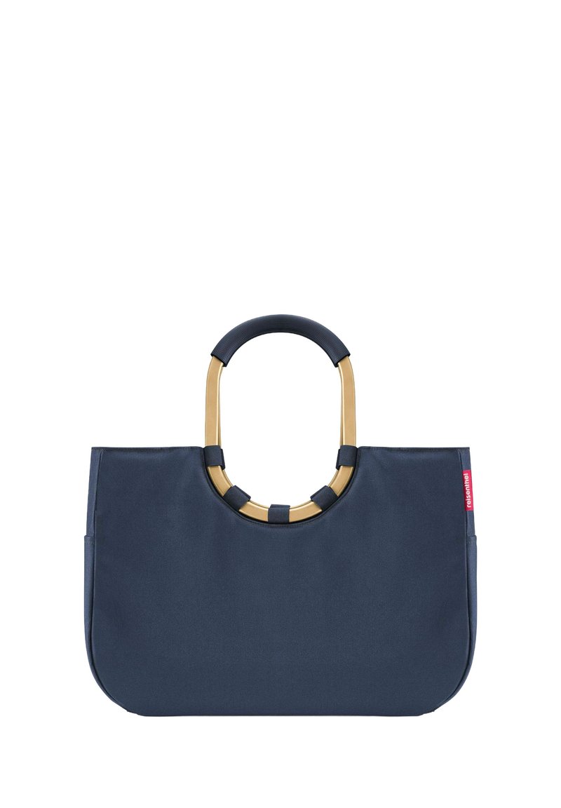 Sac fourre-tout en tissu bleu marine avec une forme structurée, doté d'une poignée circulaire accentuée d'or et de poignées texturées contrastantes sur la poignée.