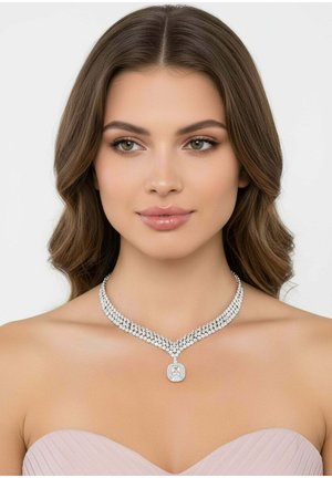 Silver necklace with layered strands of clear crystals, featuring a central pendant with a faceted design. Background is plain white.