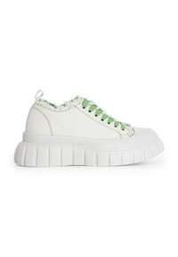 Sneaker bianchi in tela con una frangia verde testurizzata sul colletto, occhielli verdi e una spessa suola in gomma bianca rigata.