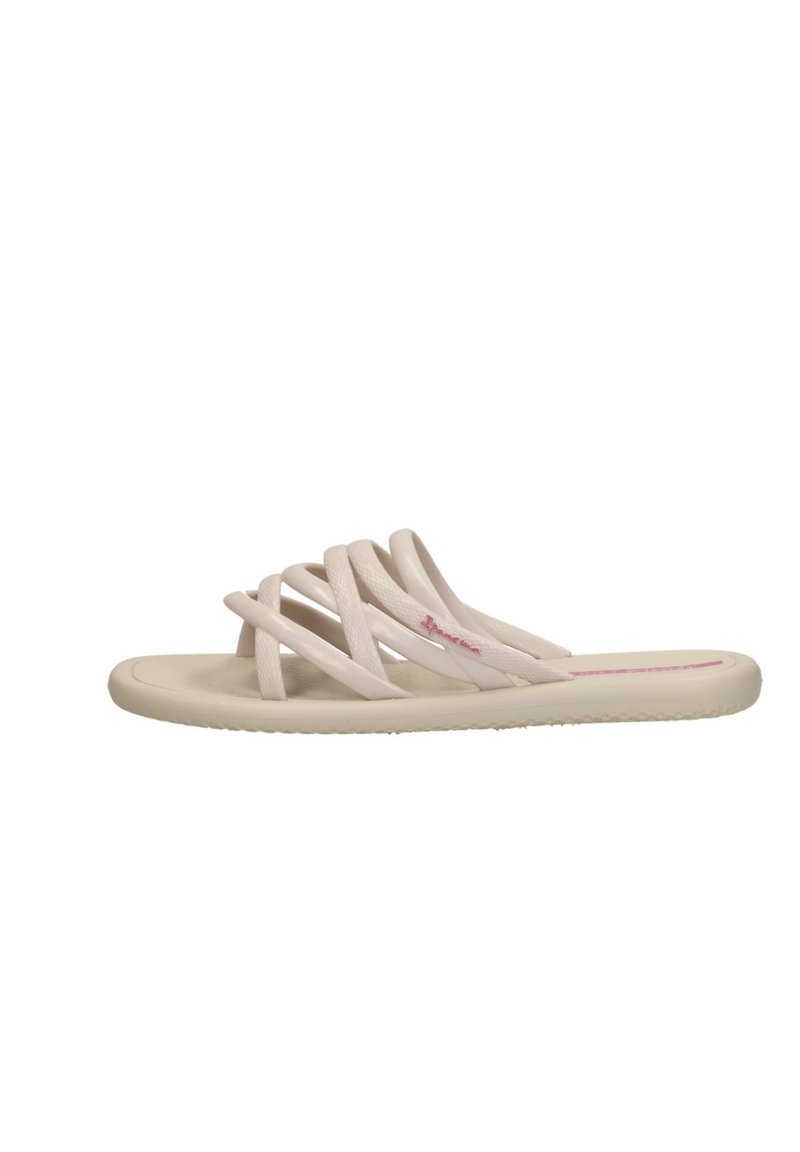 Beige platta slide-sandal med flera korsande remmar och en vadderad sula.