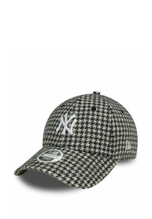 Black and white houndstooth cap with a curved brim, featuring a white embroidered logo and a size label on the visor. Cotton blend fabric.