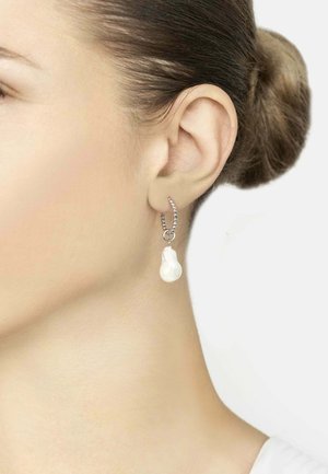 Silver hoop earring featuring a white pear-shaped pearl drop. The hoop has a beaded design with a polished finish.