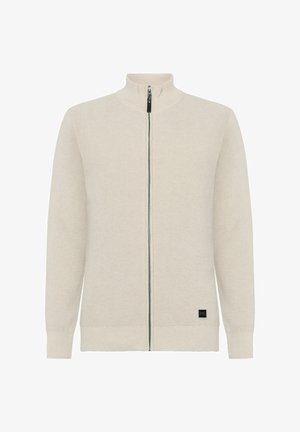 Helle beige Zip-Up-Pullover mit hohem Kragen, geripptem Material und kontrastierendem schwarzen Markenlabel nahe dem Saum.