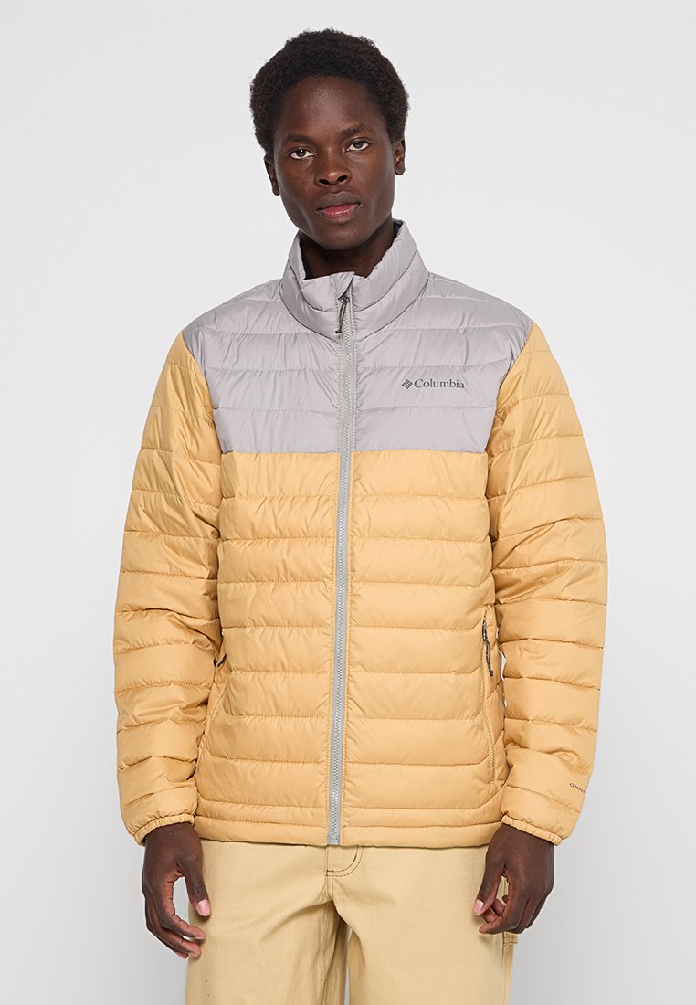 Padded jacket z szarym górnym odcinkiem i żółtym dolnym odcinkiem. Wyposażony w pełny zamek błyskawiczny i elastyczne mankiety dla lepszego dopasowania.