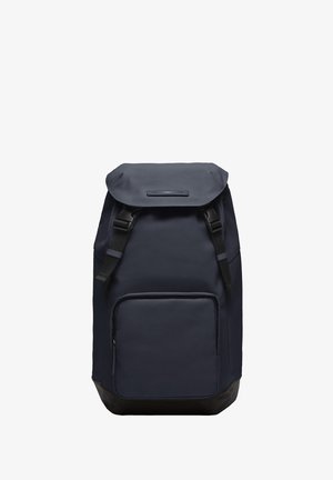 Un sac à dos bleu marine avec une finition texturée, un rouleau supérieur, des bretelles réglables, une poche zippée à l'avant et une partie inférieure noire renforcée.