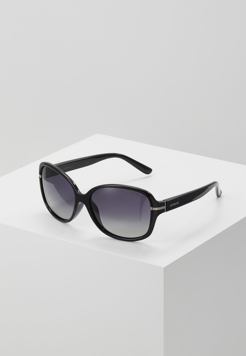 Black, oversized sunglasses with gradient lenses. Smooth plastic frame, featuring a decorative accent on the hinges. Adjustable temple arms.
