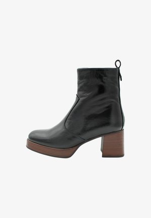 Bottine en cuir noir avec un talon carré, dotée d'un bout arrondi et d'une fermeture éclair sur le côté, ornée d'une semelle texturée marron.