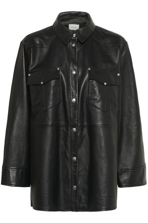Black leather shirt jacket with long sleeves, pointed collar, two chest pockets, and silver metallic snap buttons. Smooth texture, structured design.
