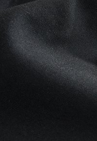 Black fabric with a smooth, slightly textured surface, displaying a woven pattern and even color throughout.