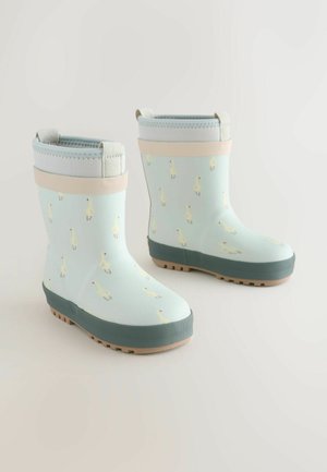 Světemodré gumové holínky se vzorem žlutých kačenek, gumový materiál, šedá podrážka a světle šedý lem s poutky pro snadné nazouvání.