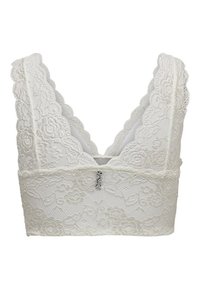 Lace bralette in white with a scalloped design and wide straps. Features floral patterns and a plunging back. Soft, textured fabric.