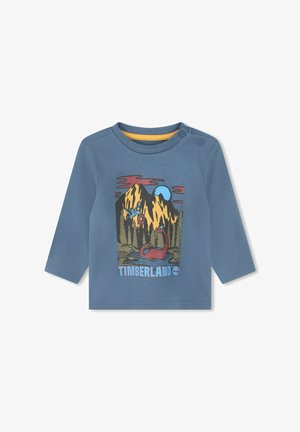 T-shirt bleu à manches longues avec un col rond, présentant un graphique coloré de montagne et le texte "TIMBERLAND" en bas.