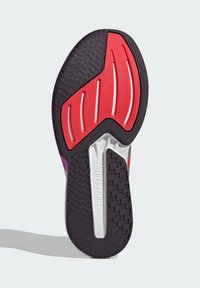 Shoe sole featuring black rubber with red and white accents, textured patterns, and a silver component marked "LIGHT STRIKE."