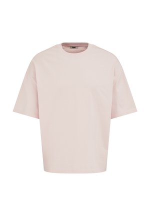 Svijetloružičasta pamučna majica kratkih rukava, široka kroja s okruglim izrezom, prikazana na bijeloj pozadini.