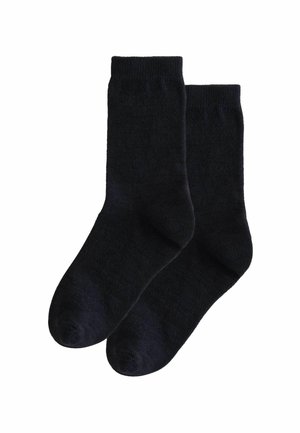 Mörkblåa strumpor med ankarlängd, tillverkade av mjukt, texturerat material med ribbat mudd. Har en rak tå och sömlös konstruktion.