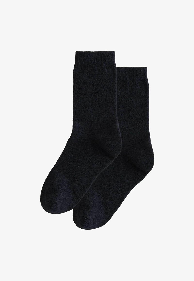 Chaussettes crew navy foncé en tissu doux et texturé avec une bordure côtelée. Caractérisées par un orteil droit et une construction sans couture.