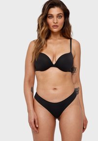 Black padded bra with adjustable straps and matching black bikini briefs. Smooth texture with a simple, seamless design.