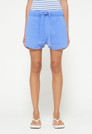 Shorts in misto cotone blu con cintura elastica e coulisse, caratterizzati da una vestibilità rilassata e tasche laterali. Texture liscia e orlo.