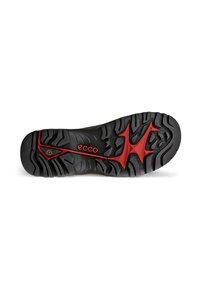 Suela de calzado ECCO, con un diseño de goma negra robusta, con profundos surcos y un destacado acento rojo en el centro. Texturizada para un mejor agarre.