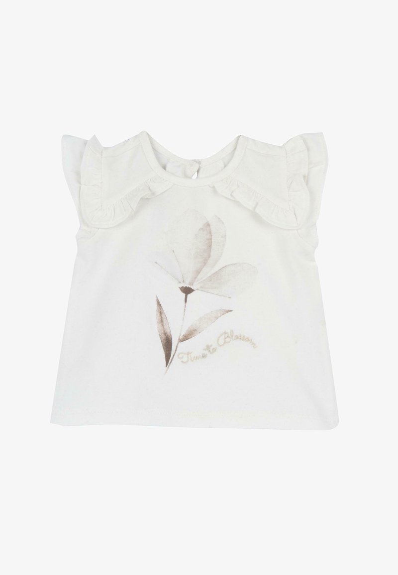 Top blanco de manga corta con hombros con volantes, con un diseño floral en beige y el texto "Time to Blossom" debajo. Tela suave de algodón.