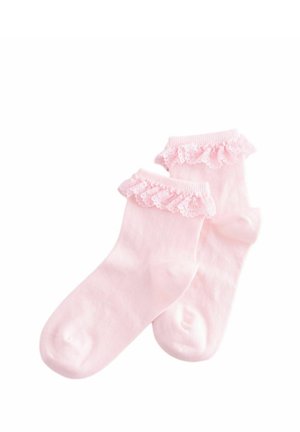 Rosa Baumwollsocken mit Rüschensaum am Knöchel. Weicher Stoff, mittellange Höhe bis zur Wade und nahtloses Zehendesign.