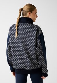 Marineblauwe trui met patroon en hoge kraag, voorzien van een getextureerd geometrisch ontwerp, geribde manchetten en een ontspannen pasvorm.