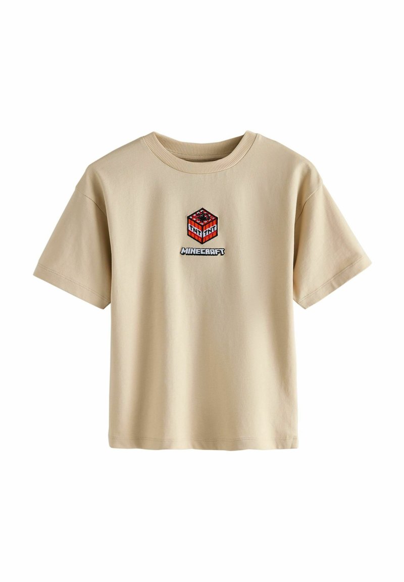 Beige katoenen t-shirt met een rode en zwarte geborduurde Minecraft TNT afbeelding gecentreerd op de borst, met korte mouwen en een ronde hals.