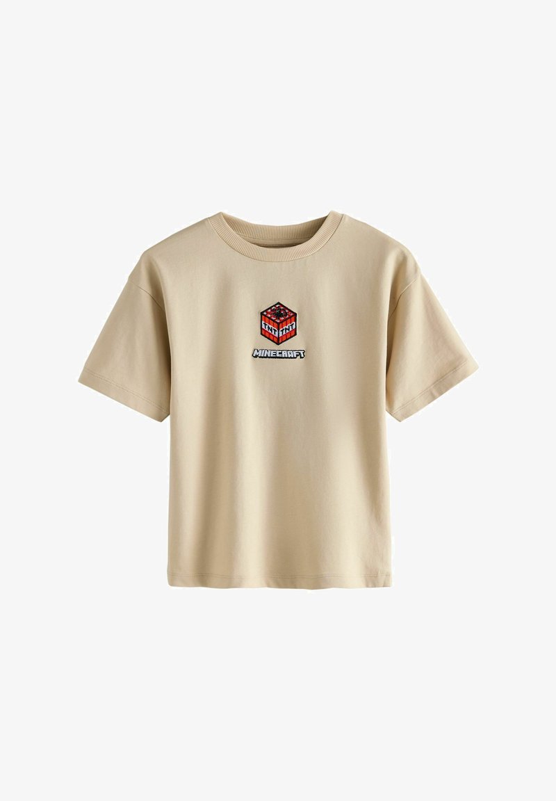 Beige katoenen t-shirt met een rode en zwarte geborduurde Minecraft TNT afbeelding gecentreerd op de borst, met korte mouwen en een ronde hals.