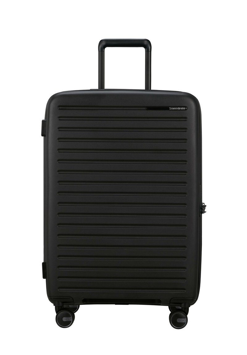Black rolling suitcase with a ridged exterior, retractable handle, and four swivel wheels. Features a zippered compartment and logo detail.