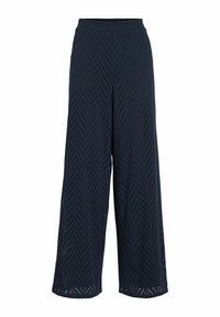 Platākā kāju bikses tumši zilos tonī, ar ševrona griezuma rakstu, elastīgu jostu un teksturētu audumu, kas nodrošina gaisa caurlaidību.