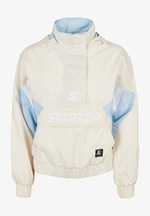 Vaalean kerma ja sininen hupullinen pullover-takki, jossa on elastiset hihansuut. Ominaisuuksiin kuuluu suuri etutasku ja "STARTER"-logo valkoisena. Sujuva kankaan tekstuuri.
