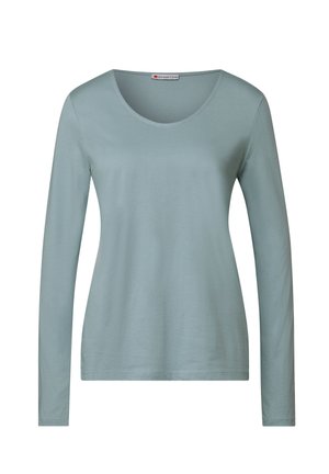 Long-sleeve, light blue shirt made from soft fabric; features a round neckline and fitted design with a smooth texture.