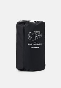Black Patagonia 55L Black Hole Duffel made of durable fabric, features a main zipper, and displays a white outline illustration on the front.